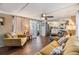 Open living room showcasing wood-look flooring, sofa, and natural light at 37246 Eileen Ave, Zephyrhills, FL 33542