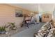 Relaxing covered patio with chairs, plants and room for storage shed at 37246 Eileen Ave, Zephyrhills, FL 33542