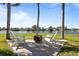 Backyard featuring comfortable lounge seating around a fire pit overlooking the lake, perfect for outdoor entertaining at 3749 Zachary St, New Port Richey, FL 34655