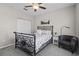 A cozy bedroom featuring a wrought iron bed, soft carpet, and white walls at 3749 Zachary St, New Port Richey, FL 34655