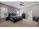 The bedroom features an accent wall with dark furniture and carpeted flooring at 3749 Zachary St, New Port Richey, FL 34655