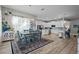 Spacious kitchen and dining area featuring modern appliances, island, and elegant decor and flooring at 3749 Zachary St, New Port Richey, FL 34655