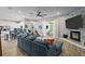 Open-concept living room featuring a stone fireplace, comfortable seating, and seamless flow to the kitchen at 3749 Zachary St, New Port Richey, FL 34655