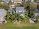 Aerial view of a two-story home with a green lawn, mature landscaping, and a paved driveway at 3749 Zachary St, New Port Richey, FL 34655