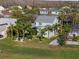 Aerial view of a two-story home with a green lawn, mature landscaping, and a paved driveway at 3749 Zachary St, New Port Richey, FL 34655