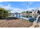 Private boat dock featuring a well-maintained walkway, a boat, and waterfront access for recreational enjoyment at 4291 Flexer Dr, Hernando Beach, FL 34607