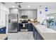 Modern kitchen with stainless steel appliances, two-tone cabinets, and marble tile floors at 4291 Flexer Dr, Hernando Beach, FL 34607