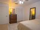 Bedroom with light wood floors, white walls and a dresser with a mirror at 4408 13Th W Ave, Bradenton, FL 34209