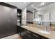 Elegant bathroom featuring a dual sink vanity with granite countertop, and dark wood cabinetry at 449 S 12Th St # 1705, Tampa, FL 33602