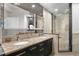 Modern bathroom with dual sinks, granite countertop, and a glass-enclosed shower at 449 S 12Th St # 1705, Tampa, FL 33602