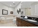 Elegant bathroom featuring double vanity, soaking tub, and decorative mirror, offering a spa-like experience at 449 S 12Th St # 1705, Tampa, FL 33602