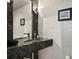 Contemporary bathroom featuring a black marble countertop and modern fixtures at 449 S 12Th St # 1705, Tampa, FL 33602