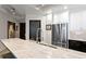 Modern kitchen featuring stainless steel appliances, white cabinets, and a light marble countertop island at 449 S 12Th St # 1705, Tampa, FL 33602