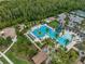 Aerial view of the community pool, clubhouse, playground, tennis court, and surrounding community at 4575 Tivoli Dr, Wesley Chapel, FL 33543