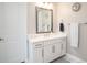 Bathroom featuring a white vanity with quartz countertop, a modern mirror, and tile flooring at 4575 Tivoli Dr, Wesley Chapel, FL 33543