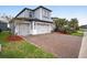 Beautiful two-story home boasts a paver driveway and a three-car garage at 4575 Tivoli Dr, Wesley Chapel, FL 33543