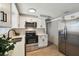 Modern kitchen featuring stainless steel appliances, ample counter space, and neutral color tones at 4733 Bonton Dr, Holiday, FL 34690