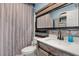 Rustic bathroom with wood accents, shower with striped curtain, and white sink at 4831 Fairfield S Ave, St Petersburg, FL 33711