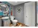 Unique bathroom featuring gray walls, wood floors, and decorative art at 4831 Fairfield S Ave, St Petersburg, FL 33711