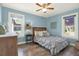 Bedroom featuring blue walls, wood floors, and two windows that let in natural light at 4831 Fairfield S Ave, St Petersburg, FL 33711