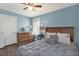 Bedroom featuring blue walls, wood floors, and window letting in natural light at 4831 Fairfield S Ave, St Petersburg, FL 33711