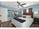 Cozy bedroom featuring blue walls, wood floors, and a ceiling fan with a light at 4831 Fairfield S Ave, St Petersburg, FL 33711