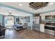 Open-concept living space with hardwood floors, a ceiling fan, stainless steel appliances, and a blue accent wall at 4831 Fairfield S Ave, St Petersburg, FL 33711