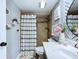Tastefully decorated bathroom with shower and patterned accent wall at 513 Hammock Pine Blvd, Clearwater, FL 33761