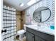Stylish bathroom with patterned accent wall and modern vanity at 513 Hammock Pine Blvd, Clearwater, FL 33761