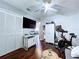 Bedroom featuring a Peloton bike, built-in storage, and a white closet, all set on rich, dark wood flooring at 513 Hammock Pine Blvd, Clearwater, FL 33761