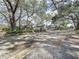 Residential community entrance with security gate and mature trees at 513 Hammock Pine Blvd, Clearwater, FL 33761