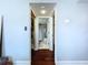 View down hallway shows access to laundry and bathroom at 513 Hammock Pine Blvd, Clearwater, FL 33761