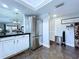 Open-concept space featuring a white kitchen with stainless appliances and a view of the Gathering room at 513 Hammock Pine Blvd, Clearwater, FL 33761