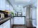 Eat in kitchen area featuring white cabinets and stainless steel refrigerator at 513 Hammock Pine Blvd, Clearwater, FL 33761