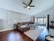 Open living room with hardwood floors and a sliding door to the screened in patio at 513 Hammock Pine Blvd, Clearwater, FL 33761