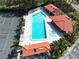 A pristine pool area with lounge chairs, cabanas, palm trees, and a sparkling jacuzzi at 513 Hammock Pine Blvd, Clearwater, FL 33761