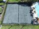 A top down view of the community's tennis courts with a pool nearby at 513 Hammock Pine Blvd, Clearwater, FL 33761