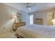 Cozy bedroom with neutral decor, ceiling fan, carpet, and a mirrored dresser creating a relaxing space at 5521 80Th N St # 315, St Petersburg, FL 33709