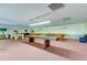 Spacious billiards room featuring multiple pool tables and shuffleboard setup at 5521 80Th N St # 315, St Petersburg, FL 33709