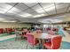 Community dining room with round tables, chairs, and plenty of natural light at 5521 80Th N St # 315, St Petersburg, FL 33709