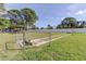 Outdoor horseshoe pit and lawn area provides residents with recreational activities, under a blue sky with trees and greenery at 5521 80Th N St # 315, St Petersburg, FL 33709