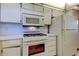 Well-lit kitchen showcasing oven, range, microwave, and refrigerator at 5521 80Th N St # 315, St Petersburg, FL 33709