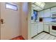 Compact white kitchen next to entryway at 5521 80Th N St # 315, St Petersburg, FL 33709