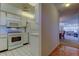 A kitchen with white appliances and tile flooring, adjacent to the dining and living room at 5521 80Th N St # 315, St Petersburg, FL 33709