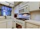 Kitchen featuring white cabinets, oven, cooktop, and microwave at 5521 80Th N St # 315, St Petersburg, FL 33709