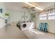 Bright community laundry room with folding table and multiple washing machines at 5521 80Th N St # 315, St Petersburg, FL 33709
