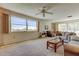Inviting living room features neutral carpet, comfortable seating, ceiling fan, and large windows offering plenty of natural light at 5521 80Th N St # 315, St Petersburg, FL 33709