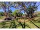 Outdoor picnic and grilling area with a grill, seating, and mature trees, perfect for outdoor dining and relaxation at 5521 80Th N St # 315, St Petersburg, FL 33709