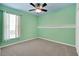 Bright bedroom with carpet, ceiling fan, and window at 5703 Tanagerside Rd, Lithia, FL 33547