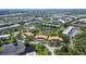 Beautiful aerial view of a community with mature trees, a serene lake, and well-maintained buildings at 5920 80Th N St # 107, St Petersburg, FL 33709